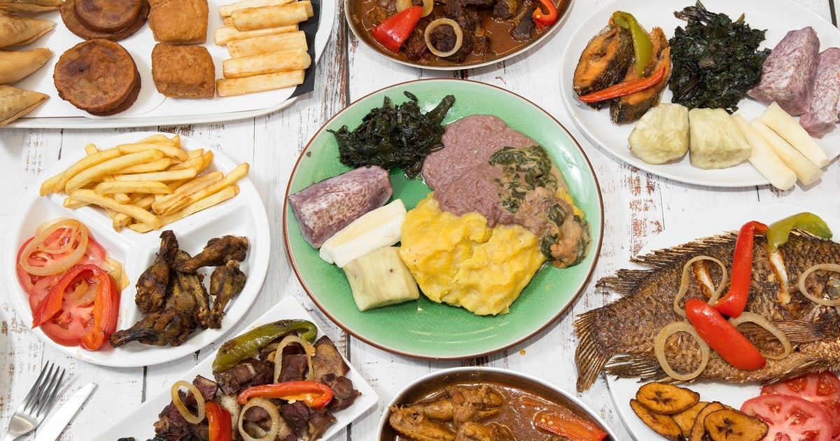 Ugandan meal spread with fish, matooke, vegetables and other accompaniments
