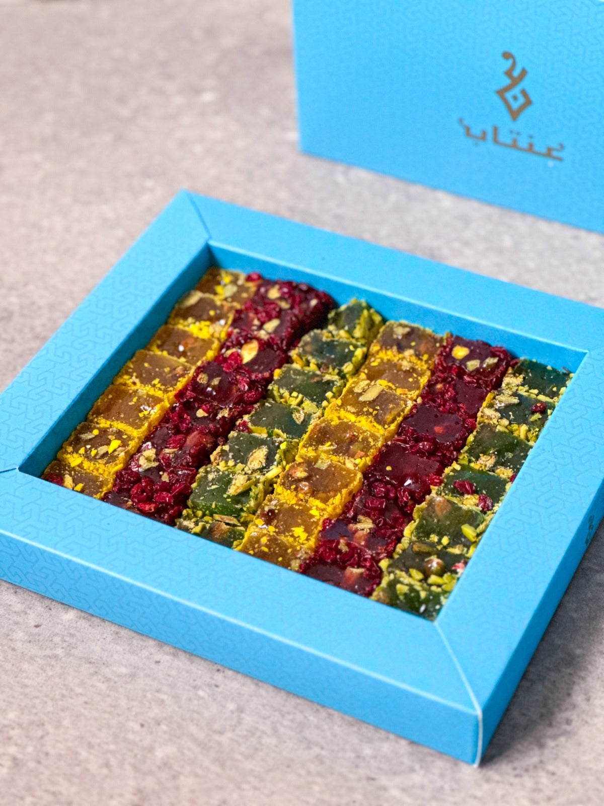Lemon, apple and pomegranate delight with pistachios in a large box