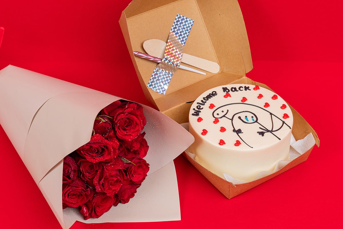 Holding welcome back cake With flowers