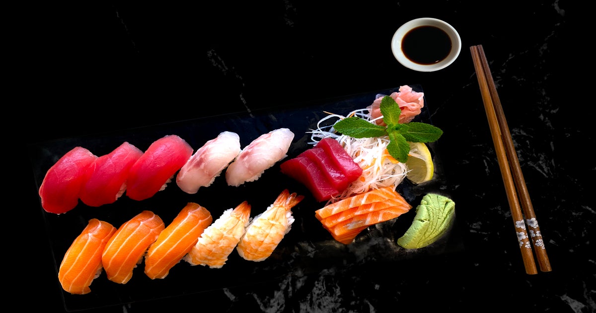 Assorted fresh sushi gunkan maki with seafood. set of gunkans in